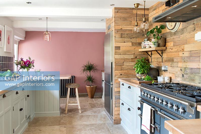 Pink painted feature wall in modern country kitchen 