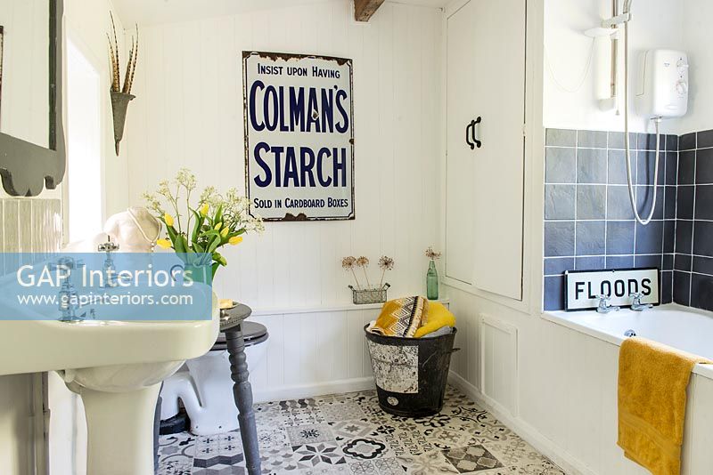 Vintage shop signage on wall in modern country bathroom 
