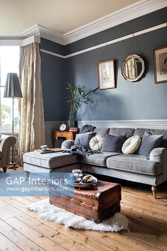 Dark grey painted walls and original features in modern living room 