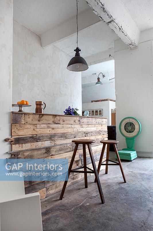 Modern kitchen counter and bar stools made from reclaimed wood 