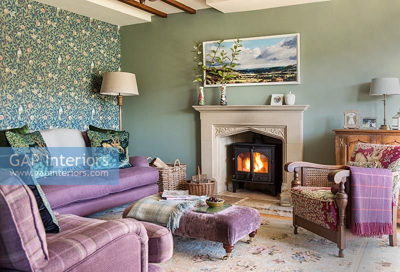 Purple sofa in green country living room 