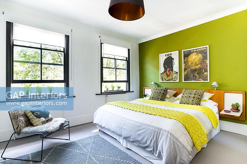 Lime green feature wall in modern bedroom 
