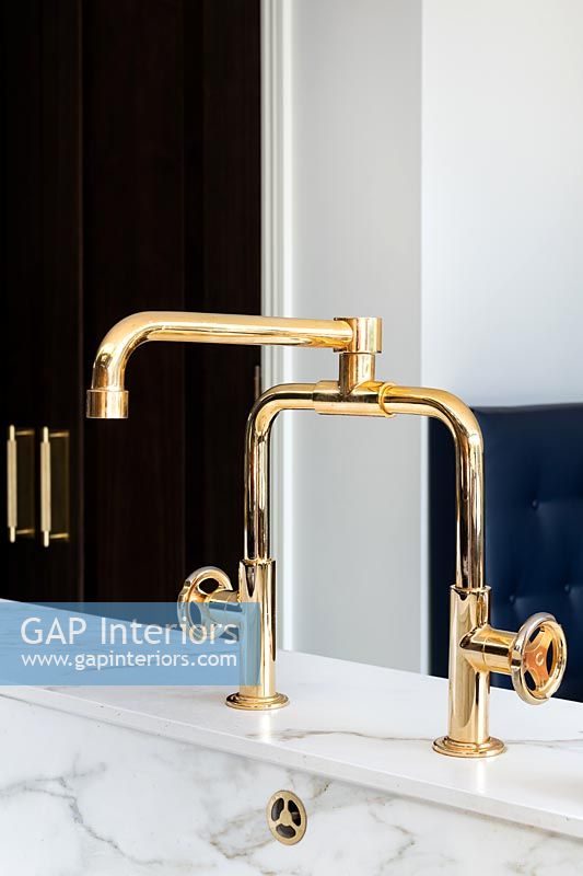 Gold taps in modern kitchen 