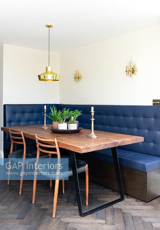 Corner banquette seating around table in modern kitchen-diner 