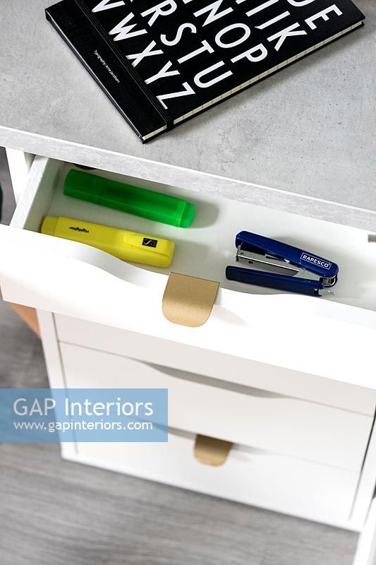 Pens and equipment in modern home office drawer