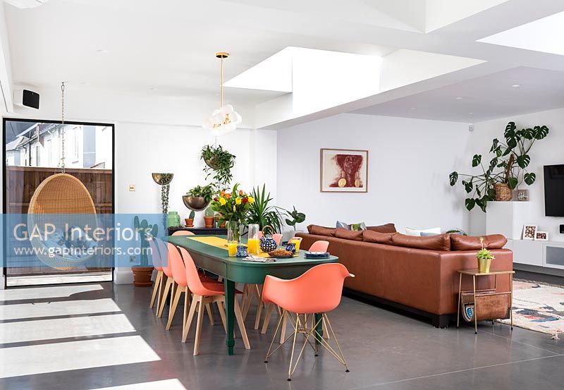 Colourful dining room with large sofa 