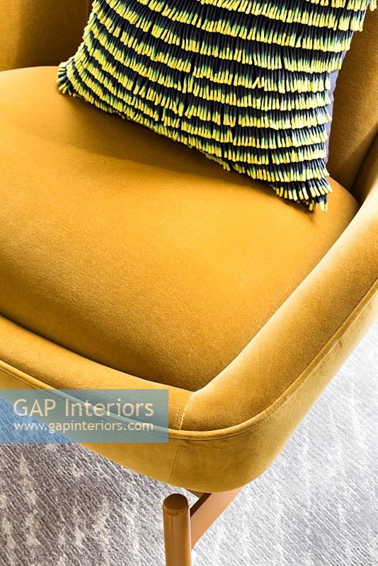 Mustard coloured upholstered chair detail 