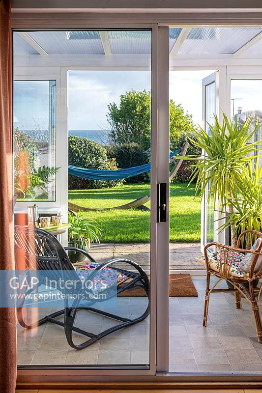 UPVC conservatory with garden access and view of the sea
