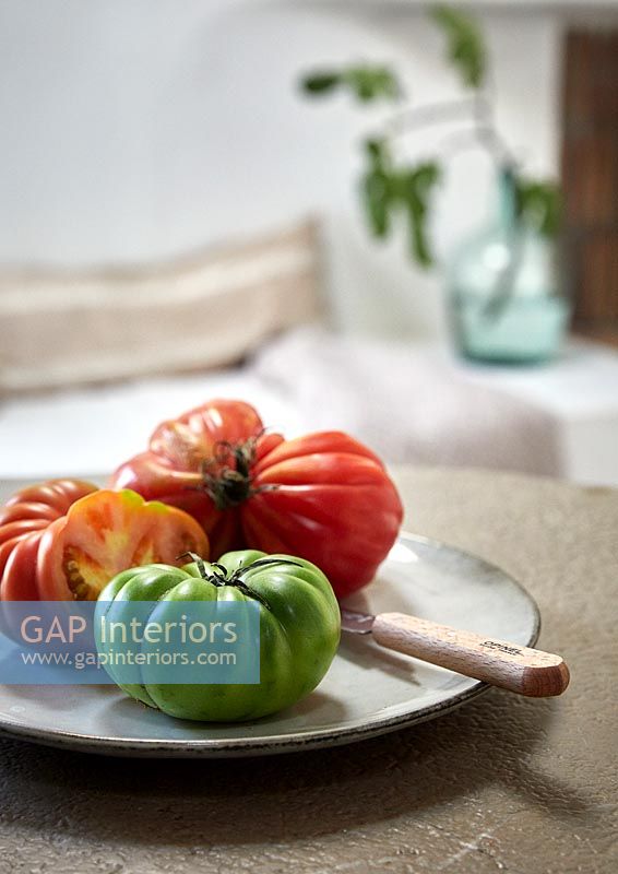 Fresh tomatoes on plate - kitchen detail  