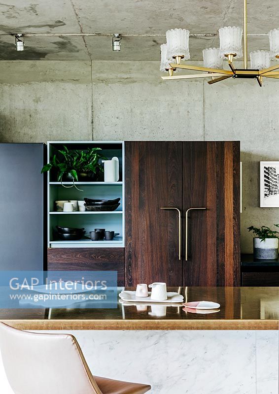 Contemporary kitchen diner area with concrete walls and ceiling