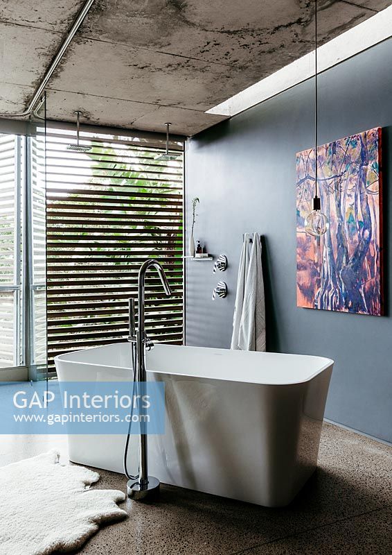 Modern ensuite bathroom with contemporary artwork on wall