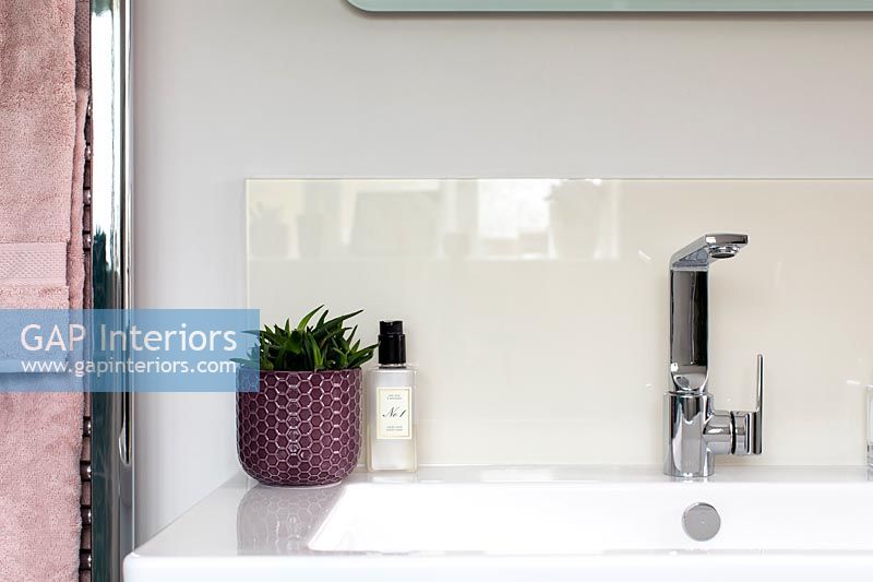 Modern bathroom sink with perspex screen splashback 