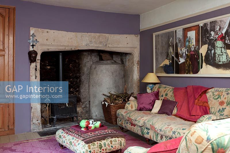 Large fireplace in colourful country living room 