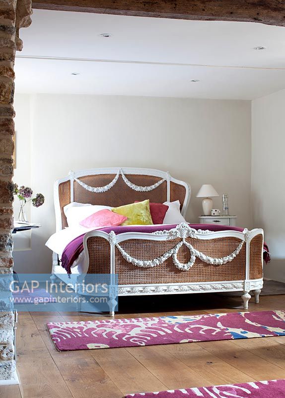 Decorative rattan bed in country bedroom 