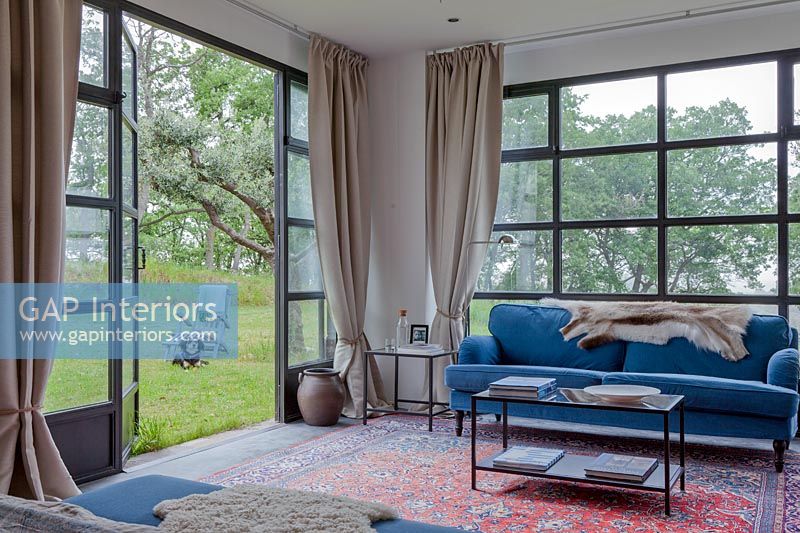 Modern living room with open patio doors to garden 