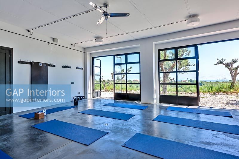 Yoga studio with open doors to scenic views of landscape beyond 