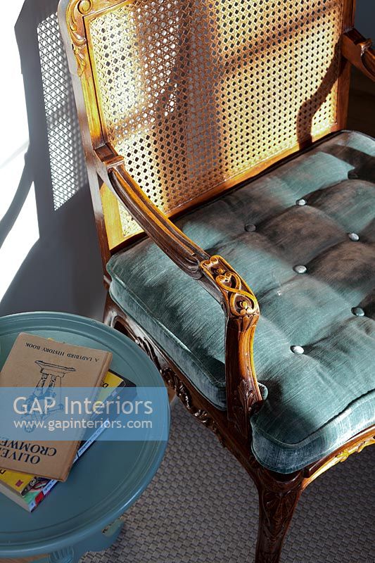 Teal blue cushion on rattan and wooden armchair - detail 