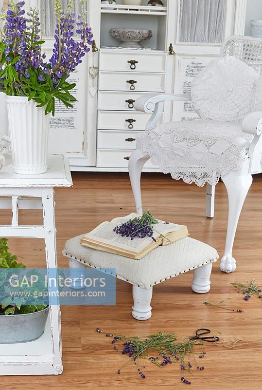 White furniture in country living room with cut flowers 