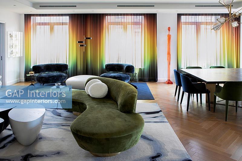 Contemporary open plan living space with rainbow coloured curtains 