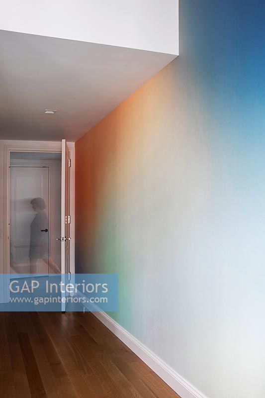 Modern hallway with rainbow colour spectrum painted walls 