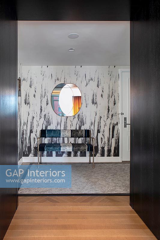 Patterned wall and seat in contemporary hallway 