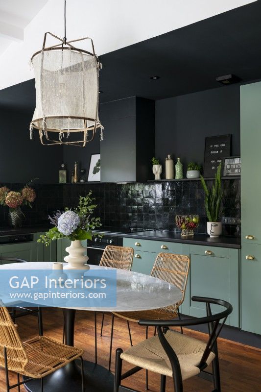 Modern green and black kitchen-diner 