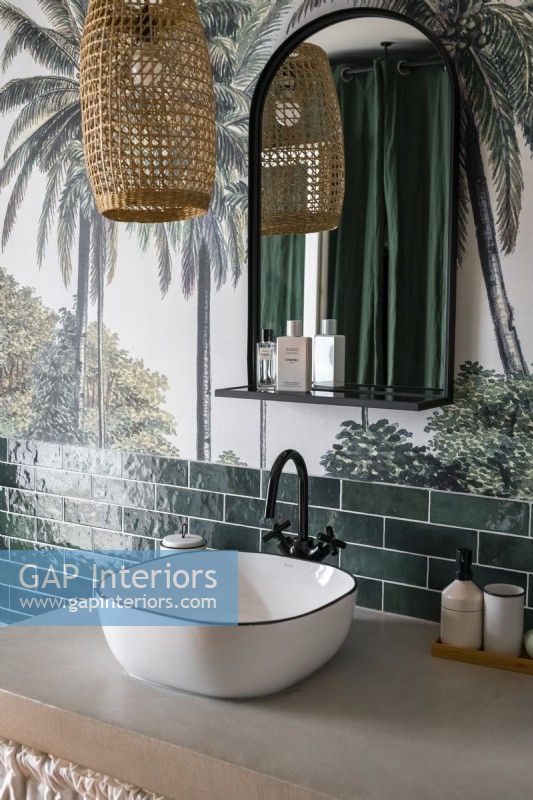 Sink in modern bathroom with tropical mural on wall