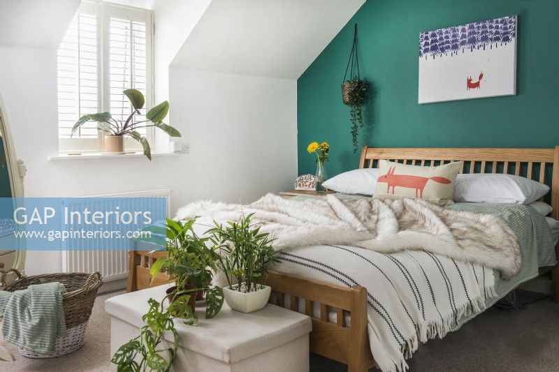 Modern bedroom with bright green painted feature wall