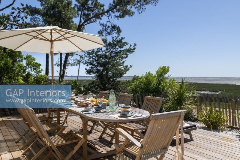 Outdoor dining area with coastal views in summer 