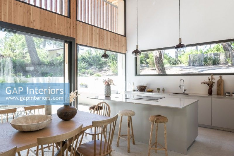 Modern kitchen diner with view to garden through large windows