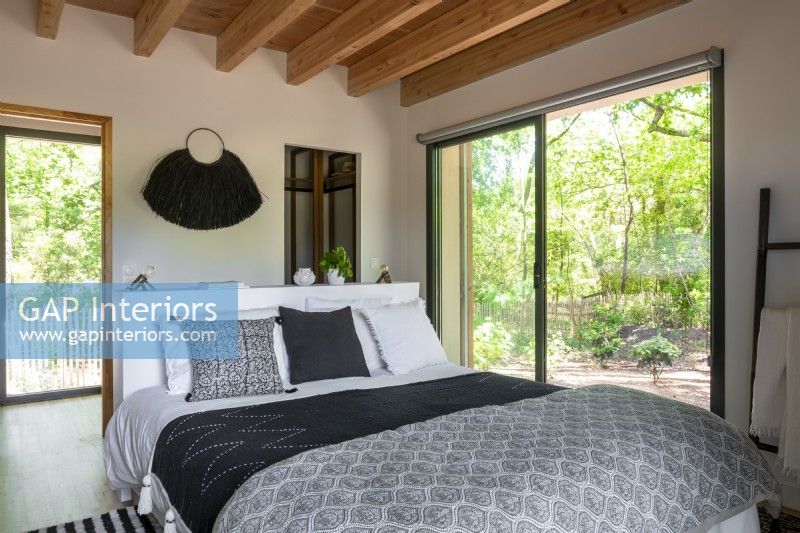 Modern country bedroom with patio doors to garden