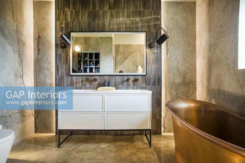 Feature wall with double sinks and copper bath in classic bathroom