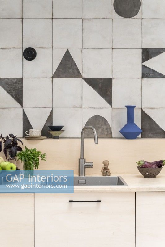 Modern kitchen sink with patterned tiled splashbacks