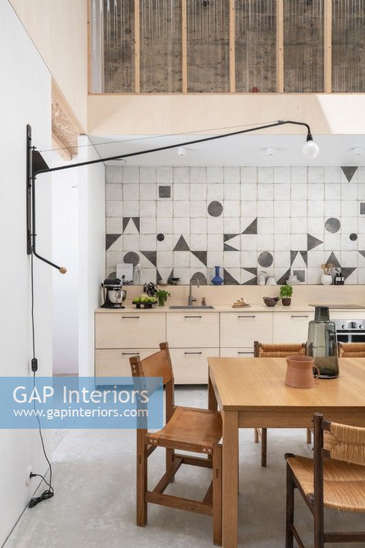 Modern kitchen diner with geometric shapes on splashback tiles