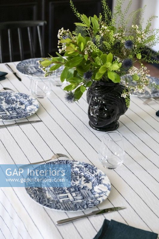Detail of classic dining table laid for dinner
