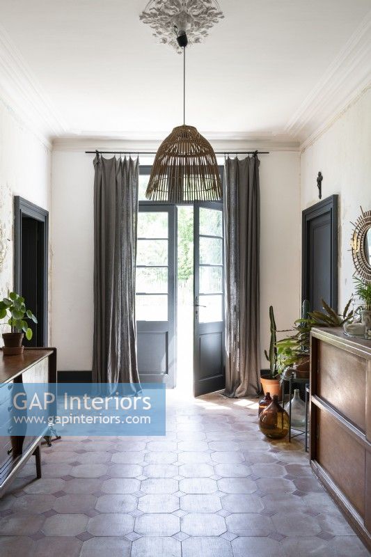 Open French doors at end of country hallway