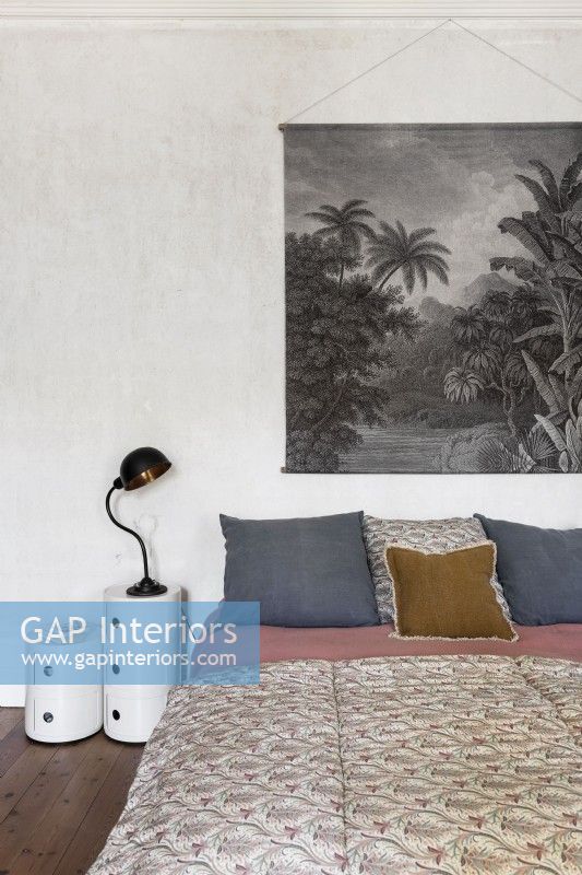 Large black and white painting hanging over bed