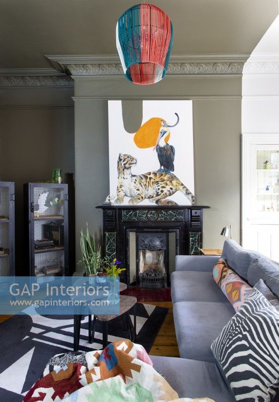 Colourful artwork above fireplace in modern living room