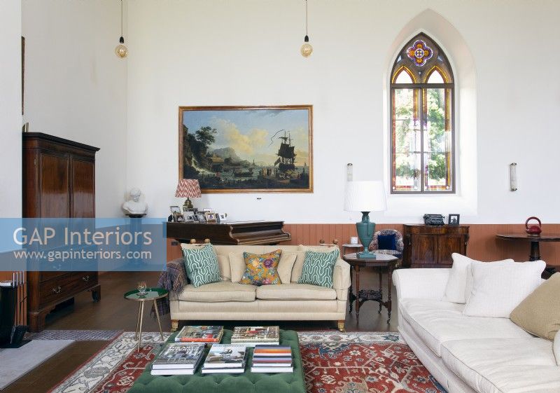 Classic style living room in coverted chapel with original stained glass