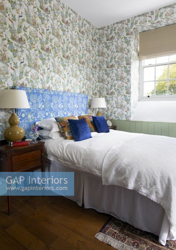 Classic bedroom with patterned wallpaper and headboard
