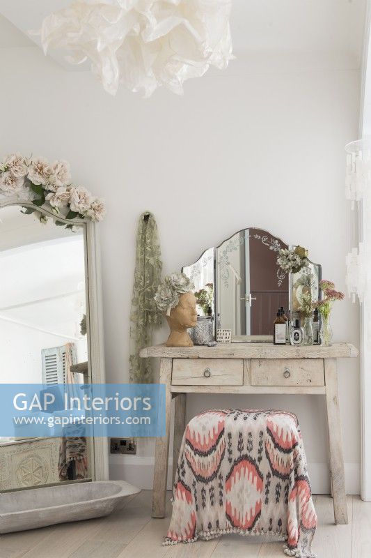 Shabby chic dressing table and mirror in feminine bedroom