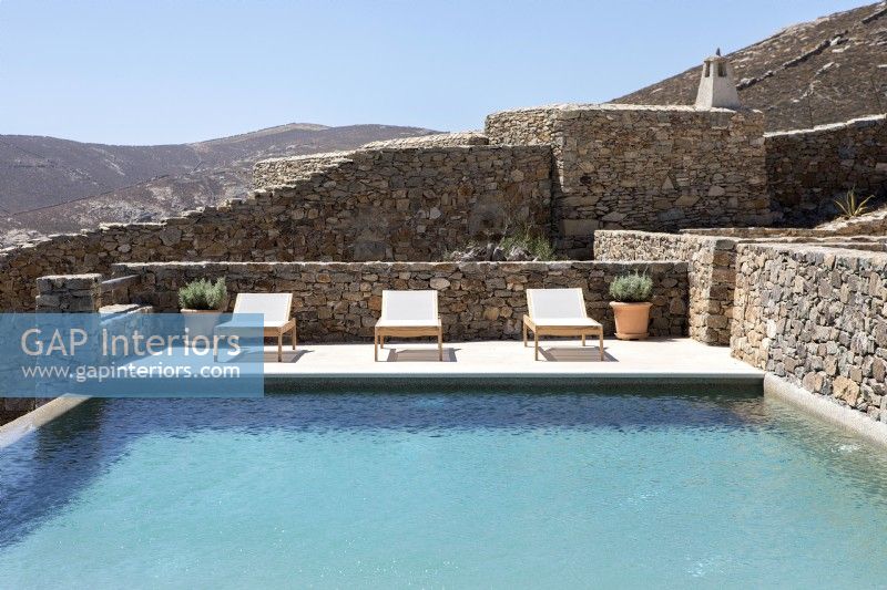 Swimming pool surrounded by stone walls