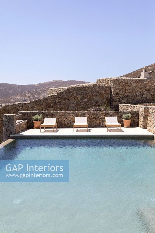 Swimming pool surrounded by stone walls