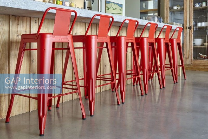 Red bar stools in modern kitchen