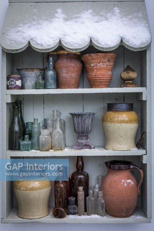 Outdoor shelves with a collection of vases, pots and jars