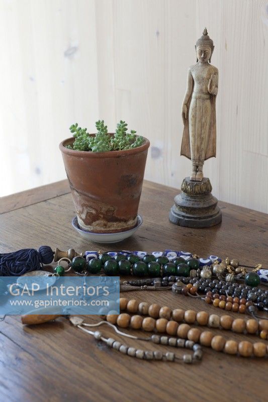 Dressing table details, antique Buddha and beads