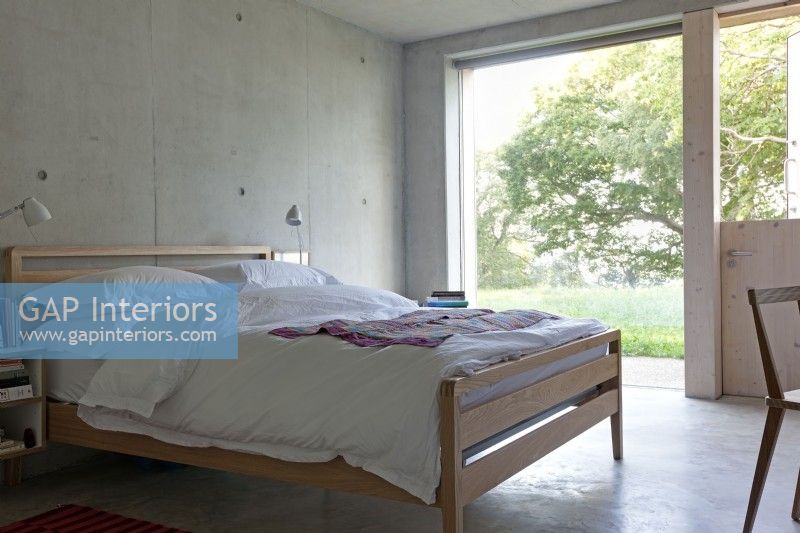 Contemporary bedroom with concrete floors and walls