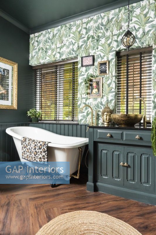 Modern green painted bathroom with botanical wallpaper