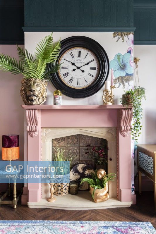Clock over colourful fireplace and mantlepiece