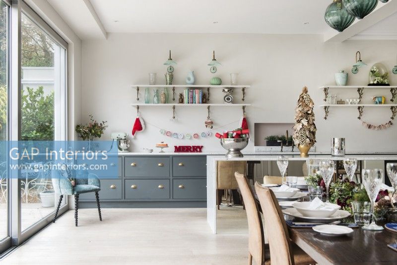 Dining table decorated for Christmas in modern kitchen-diner 